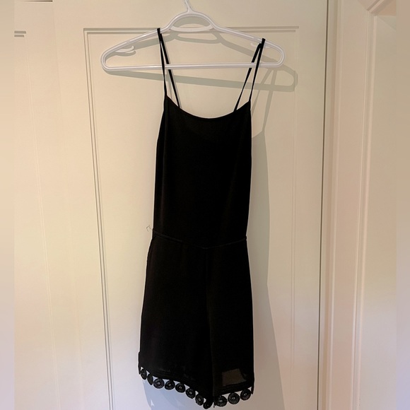 Black romper with crossbody back - Picture 1 of 3